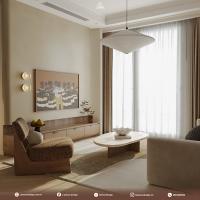 Góc không gian tông màu beige kem dịu mắt trong thiết kế phòng khách tối giản, nơi ánh sáng tự nhiên tràn ngập qua rèm voan và đèn thả trần nghệ thuật lớn tạo hiệu ứng thị giác thư giãn.